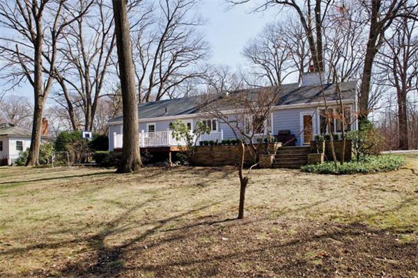 370 Quinobequin Road Newton, MA 02468 - Photo 7 of 7 a view of a house with a yard covered in snow