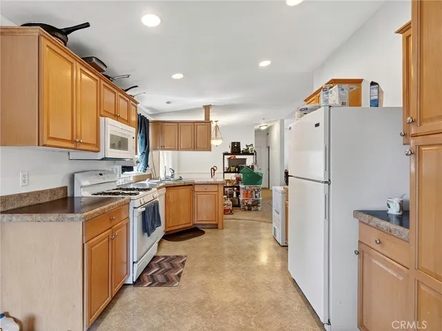 a kitchen with a refrigerator a stove top oven a sink and dishwasher