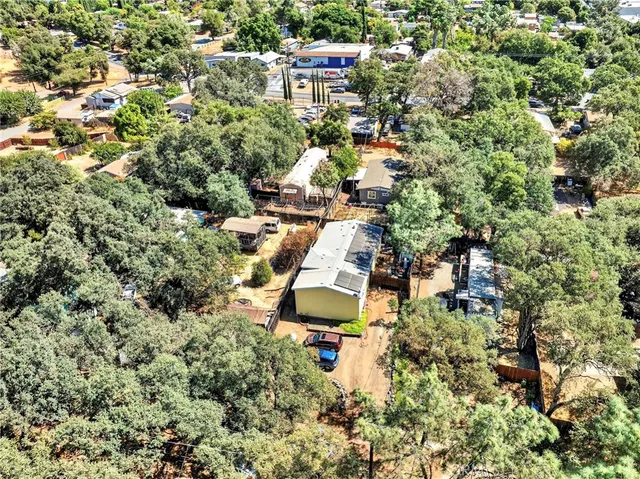an aerial view of a house with a yard and lake view