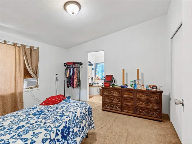 a bedroom with bed and a window