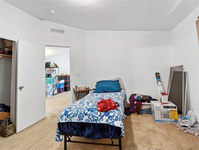 a bedroom with furniture and a flat screen tv