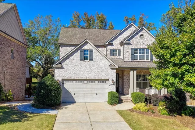 a view of a house with a yard and potted plants