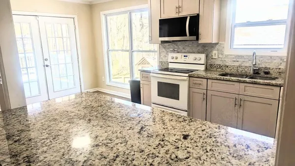 a kitchen with a stove a sink and a microwave
