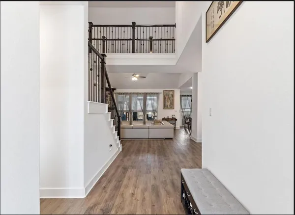 a view of entryway and hall with wooden floor