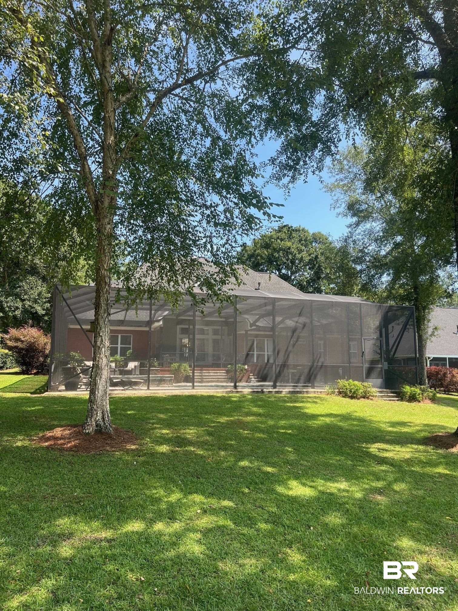 8775 Dawes Lake Road North Mobile, AL 36619 - Photo 49 of 59 View of grassy yard with glass enclosure