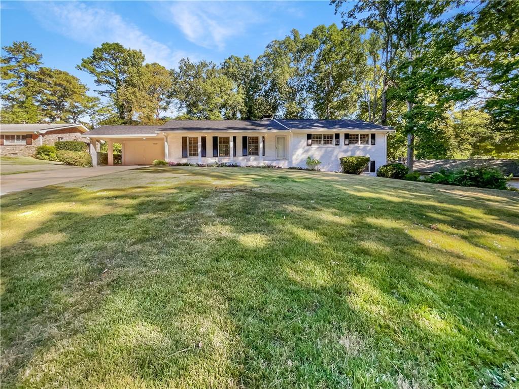 4372 Langdon Drive Decatur, GA 30035 - Photo 1 of 1 a front view of a house with a garden