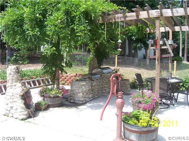 3307 Whitehouse Road Colonial Heights, VA 23834 - Photo 11 of 12 a view of a patio with table and chairs potted plants