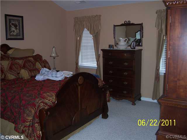 3307 Whitehouse Road Colonial Heights, VA 23834 - Photo 5 of 12 a bedroom with a bed and cabinets