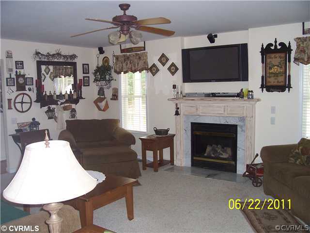 3307 Whitehouse Road Colonial Heights, VA 23834 - Photo 8 of 12 a living room with furniture a flat screen tv and a fireplace