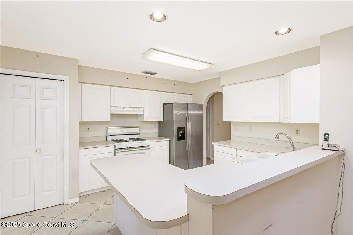 948 Pelican Lane Rockledge, FL 32955 - Photo 11 of 38 a kitchen with a sink a stove and refrigerator