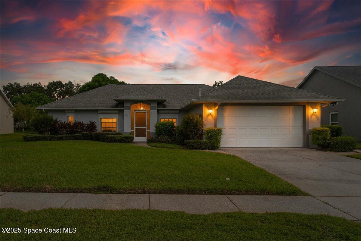 948 Pelican Lane Rockledge, FL 32955 - Photo 2 of 38 a front view of a house with a garden