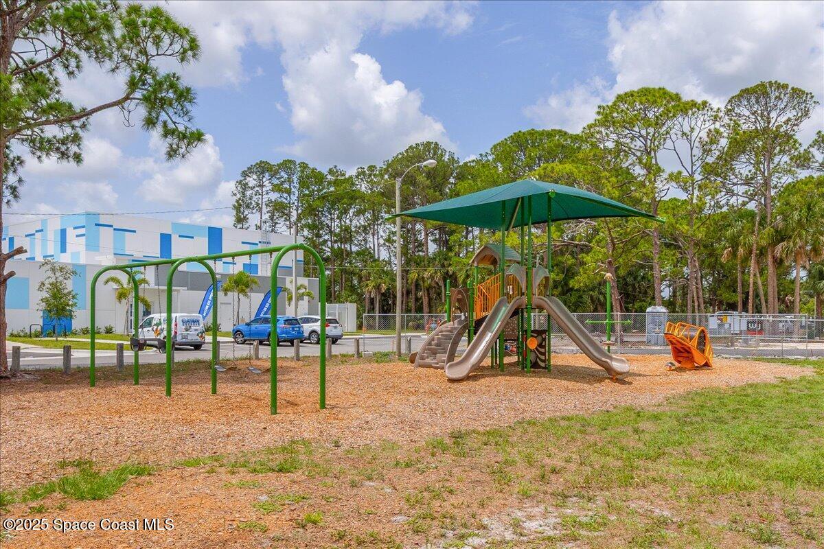948 Pelican Lane Rockledge, FL 32955 - Photo 34 of 38 a view of a park with swings and slides