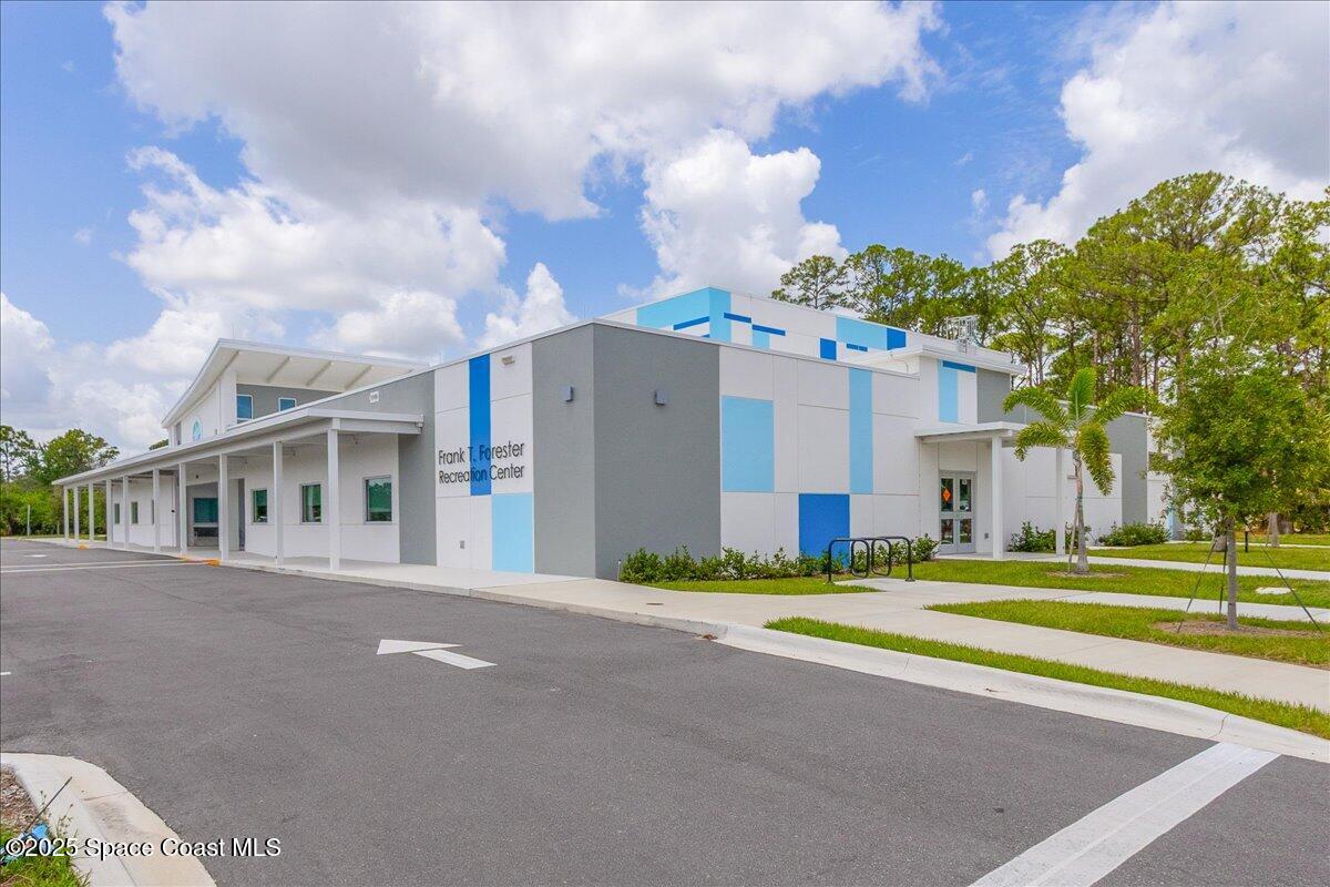 948 Pelican Lane Rockledge, FL 32955 - Photo 36 of 38 a front view of a house with a garden and trees