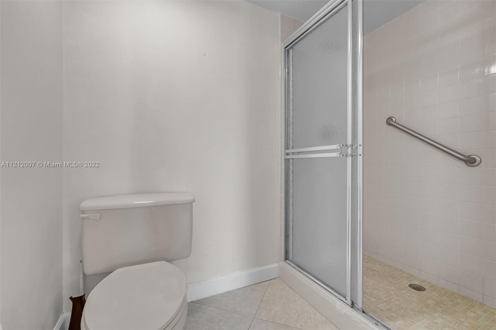 6025 Balboa Circle, Unit 202 Boca Raton, FL 33433 - Photo 24 of 28 a white toilet sitting next to a shower