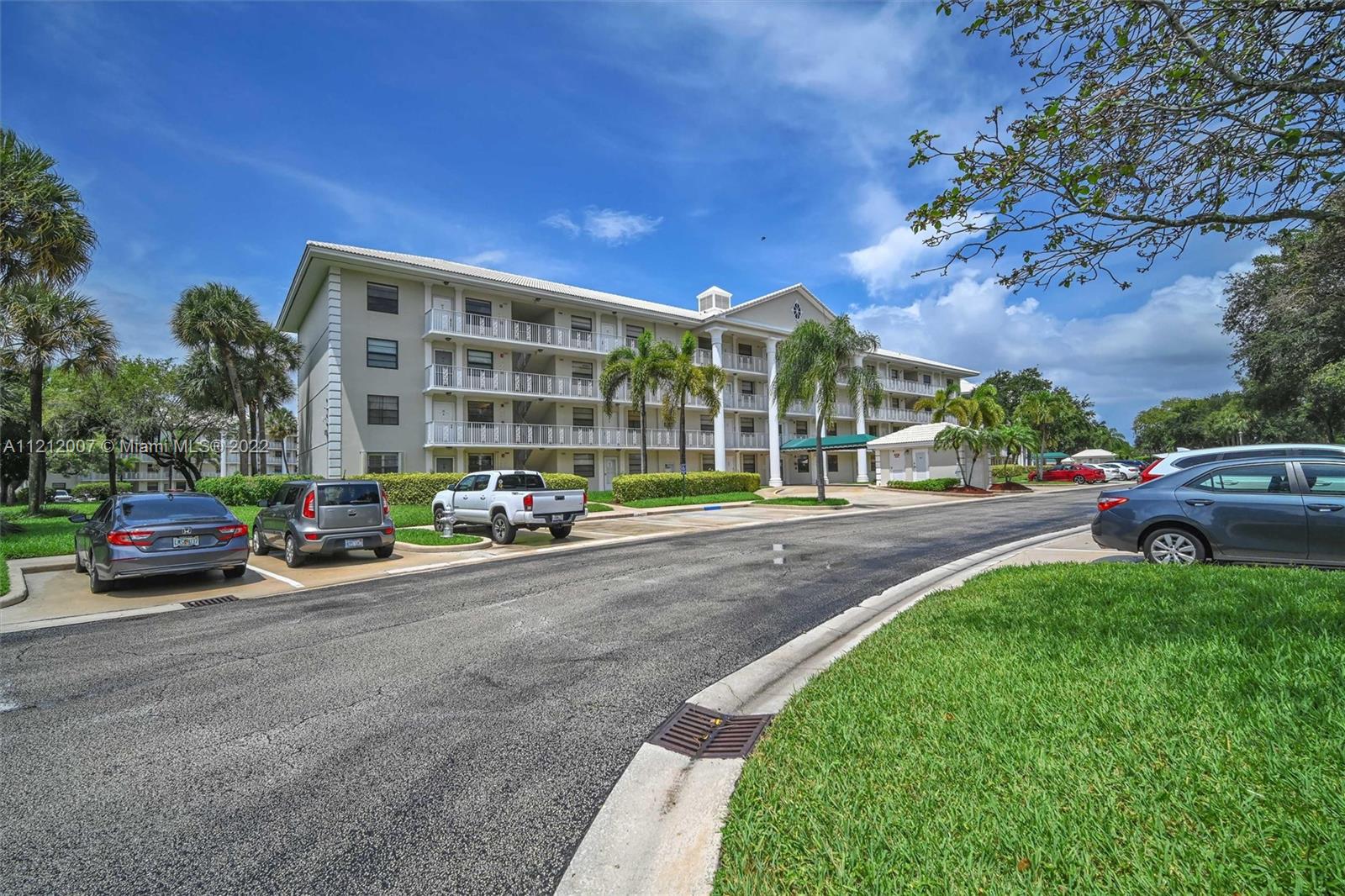6025 Balboa Circle, Unit 202 Boca Raton, FL 33433 - Photo 4 of 28 a car parked on the side of the road