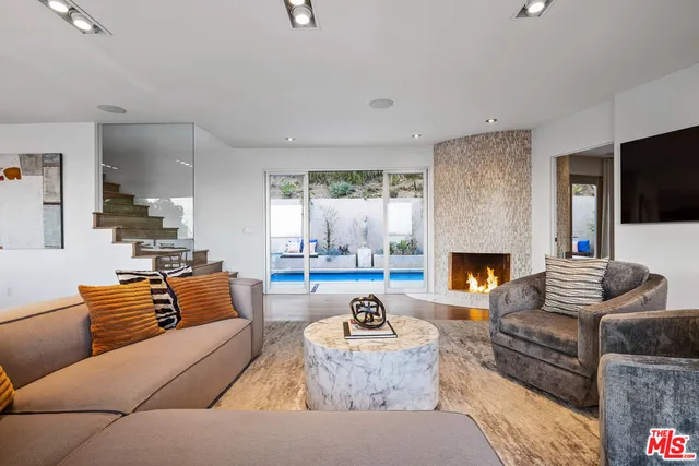 a living room with furniture fireplace and a flat screen tv