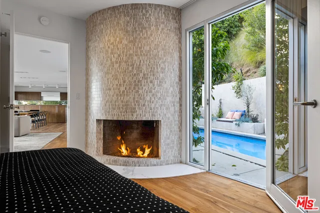 a bedroom with a bed and a fireplace