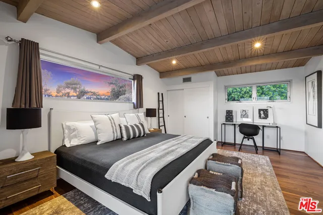 a bedroom with a bed and a table