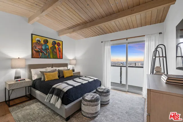 a bedroom with a large bed and a couch