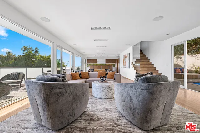 a living room with fireplace furniture and a potted plant