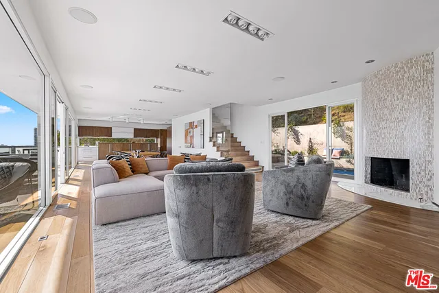 a living room with fireplace furniture and a wooden floor