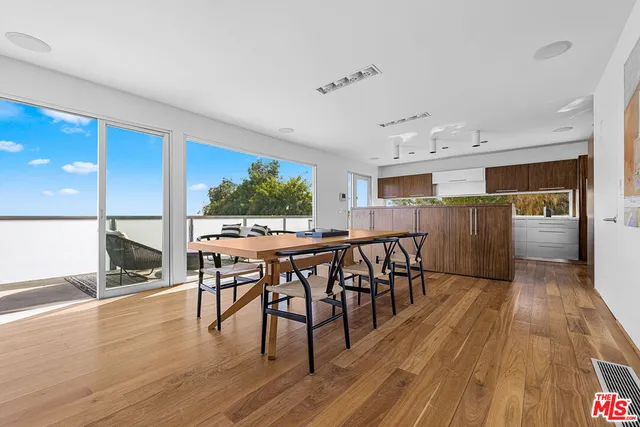 a dining room with furniture and wooden floor