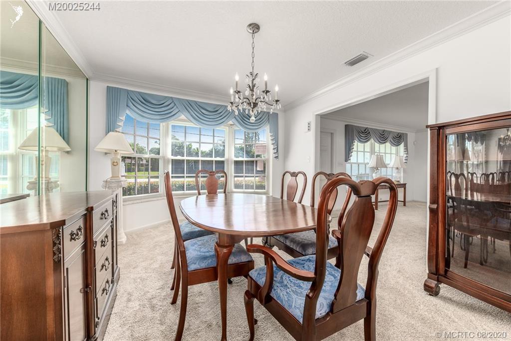 1194 Northwest Spruce Ridge Drive Stuart, FL 34994 - Photo 11 of 34 a view of a dining room with furniture window and outside view