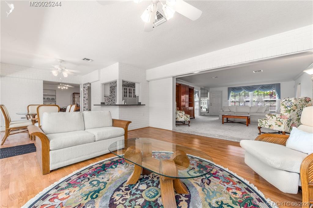 1194 Northwest Spruce Ridge Drive Stuart, FL 34994 - Photo 13 of 34 a living room with furniture and wooden floor