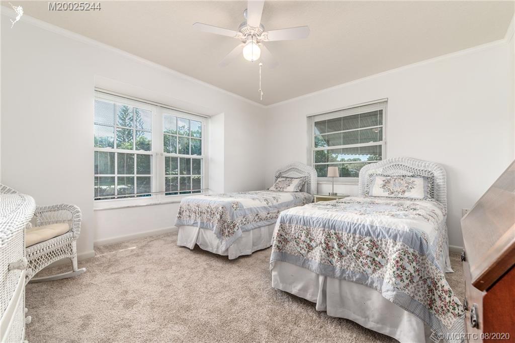 1194 Northwest Spruce Ridge Drive Stuart, FL 34994 - Photo 22 of 34 a bedroom with two beds and a window