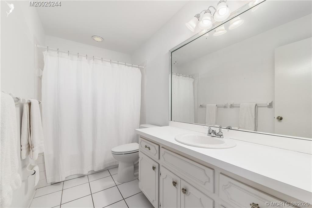 1194 Northwest Spruce Ridge Drive Stuart, FL 34994 - Photo 23 of 34 a bathroom with a sink a toilet and shower