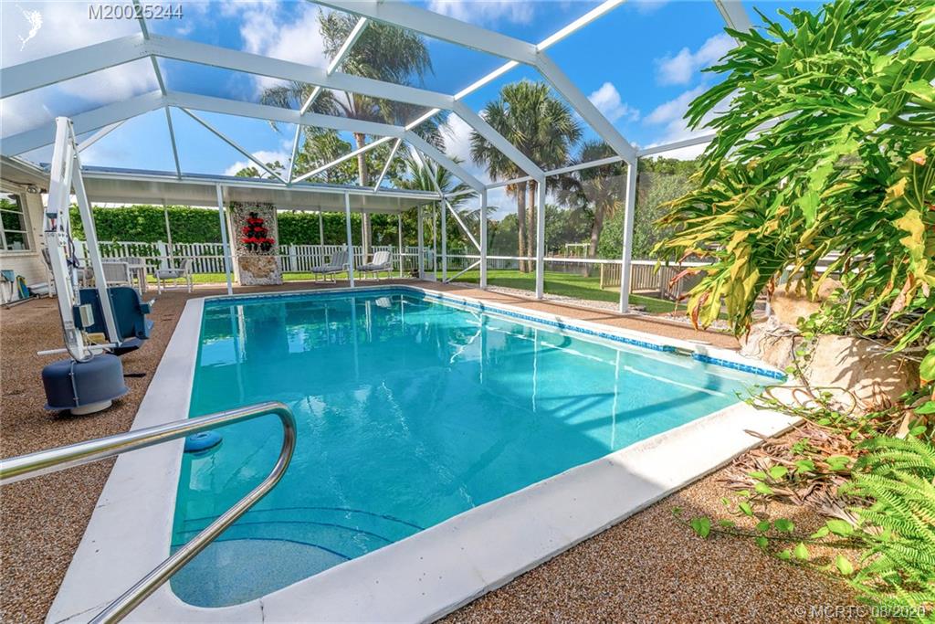 1194 Northwest Spruce Ridge Drive Stuart, FL 34994 - Photo 26 of 34 a view of a backyard with swimming pool