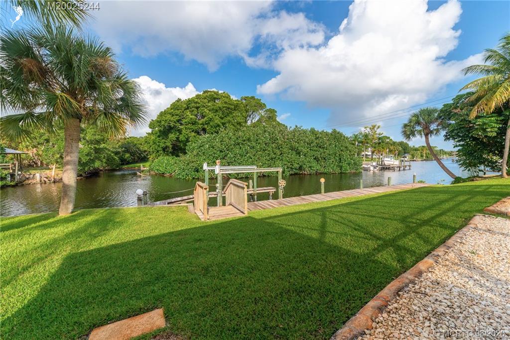 1194 Northwest Spruce Ridge Drive Stuart, FL 34994 - Photo 28 of 34 a view of a house with a yard porch and sitting area