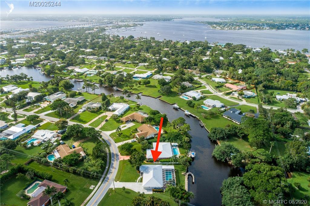 1194 Northwest Spruce Ridge Drive Stuart, FL 34994 - Photo 4 of 34 an aerial view of residential houses with outdoor space and street view