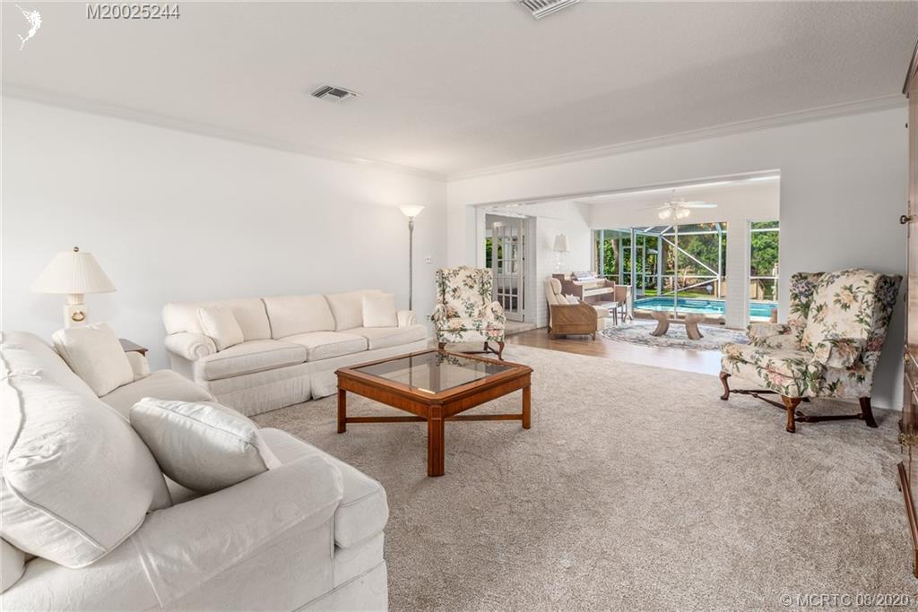1194 Northwest Spruce Ridge Drive Stuart, FL 34994 - Photo 8 of 34 a living room with furniture and a large window