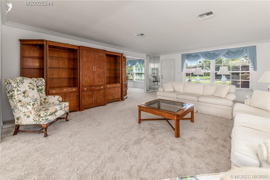 1194 Northwest Spruce Ridge Drive Stuart, FL 34994 - Photo 10 of 34 a living room with furniture and a large window