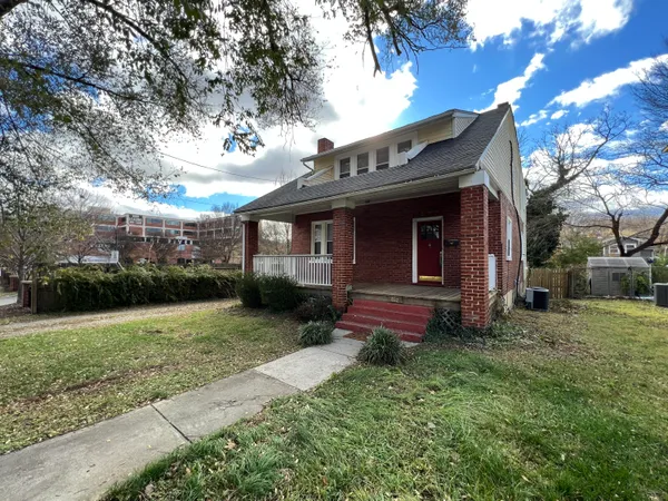 a view of a house with yard and a garden