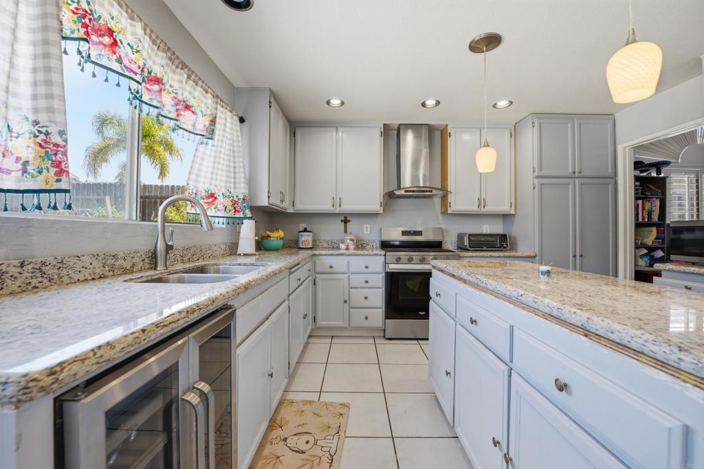 2077 Westwood Road Vista, CA 92083 - Photo 15 of 37 a kitchen with a sink stove and cabinets
