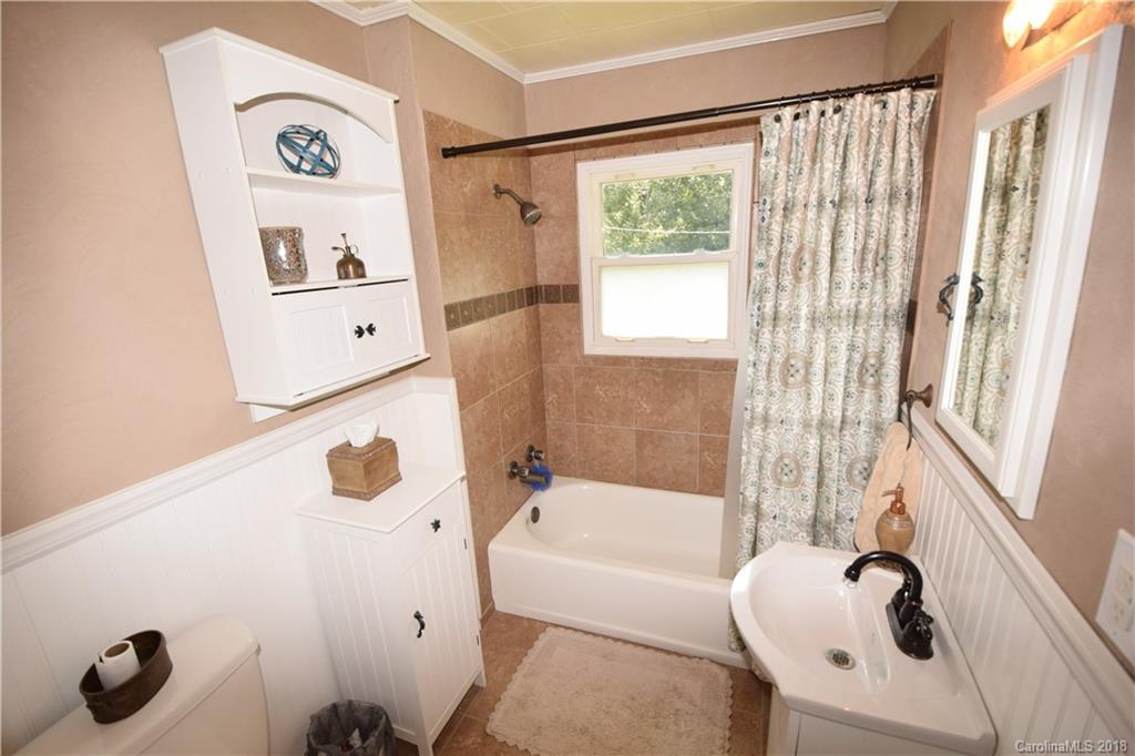 121 Thompson Road Rutherfordton, NC 28139 - Photo 8 of 29 a bathroom with a tub sink and mirror