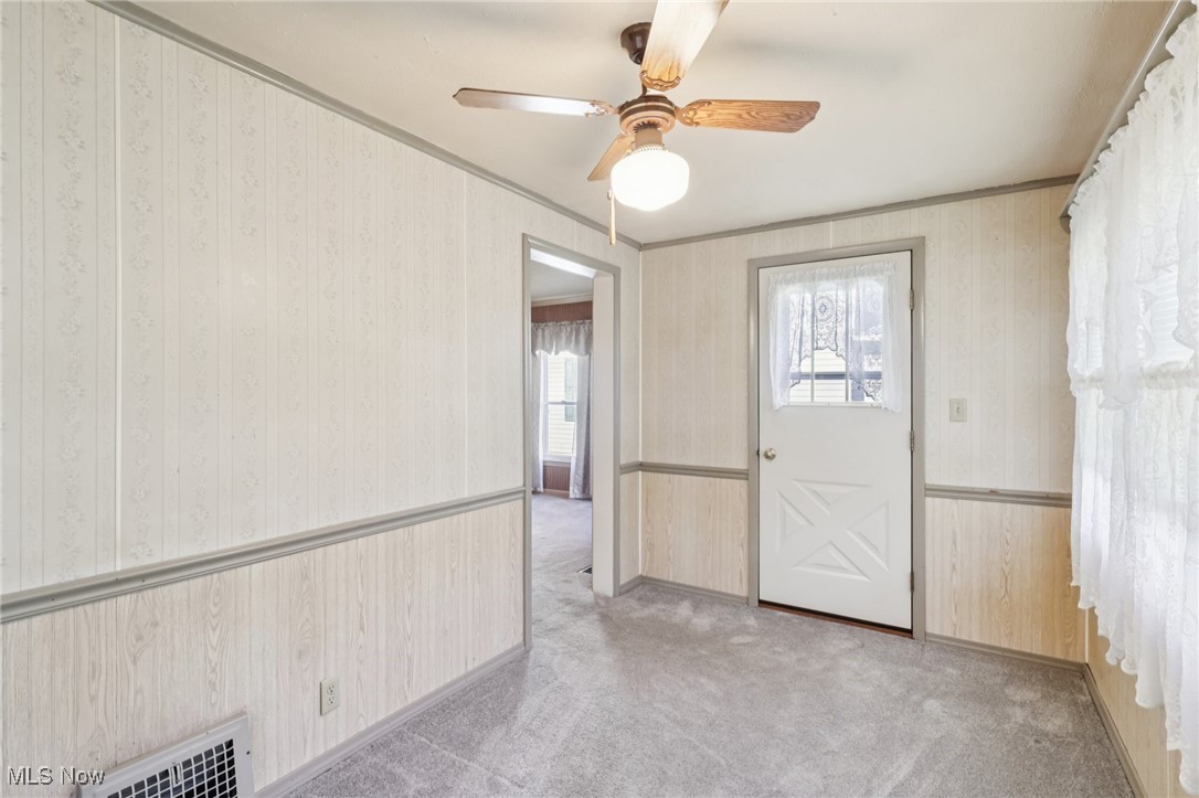 6235 Jefferson Road Ashtabula, OH 44004 - Photo 35 of 40 Foyer entrance with crown molding, carpet flooring, and ceiling fan