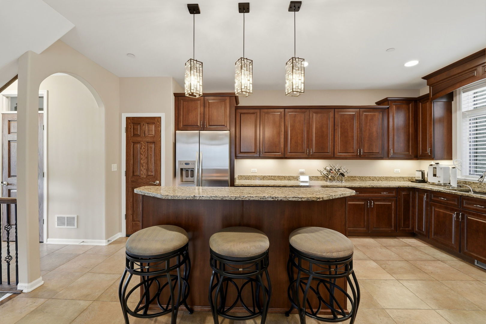 1406 Rue Paris Place Inverness, IL 60067 - Photo 12 of 35 a kitchen with stainless steel appliances granite countertop a sink a stove a dining table and chairs