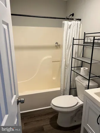 a white toilet sitting next to a bathroom sink
