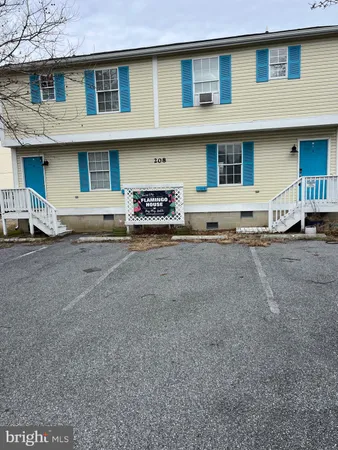 a front view of a house with parking space
