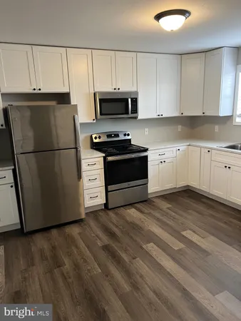 a kitchen with a refrigerator and a stove