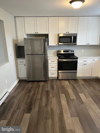 a kitchen with a refrigerator and a stove