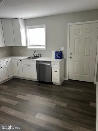 a stove top oven sitting inside of a kitchen
