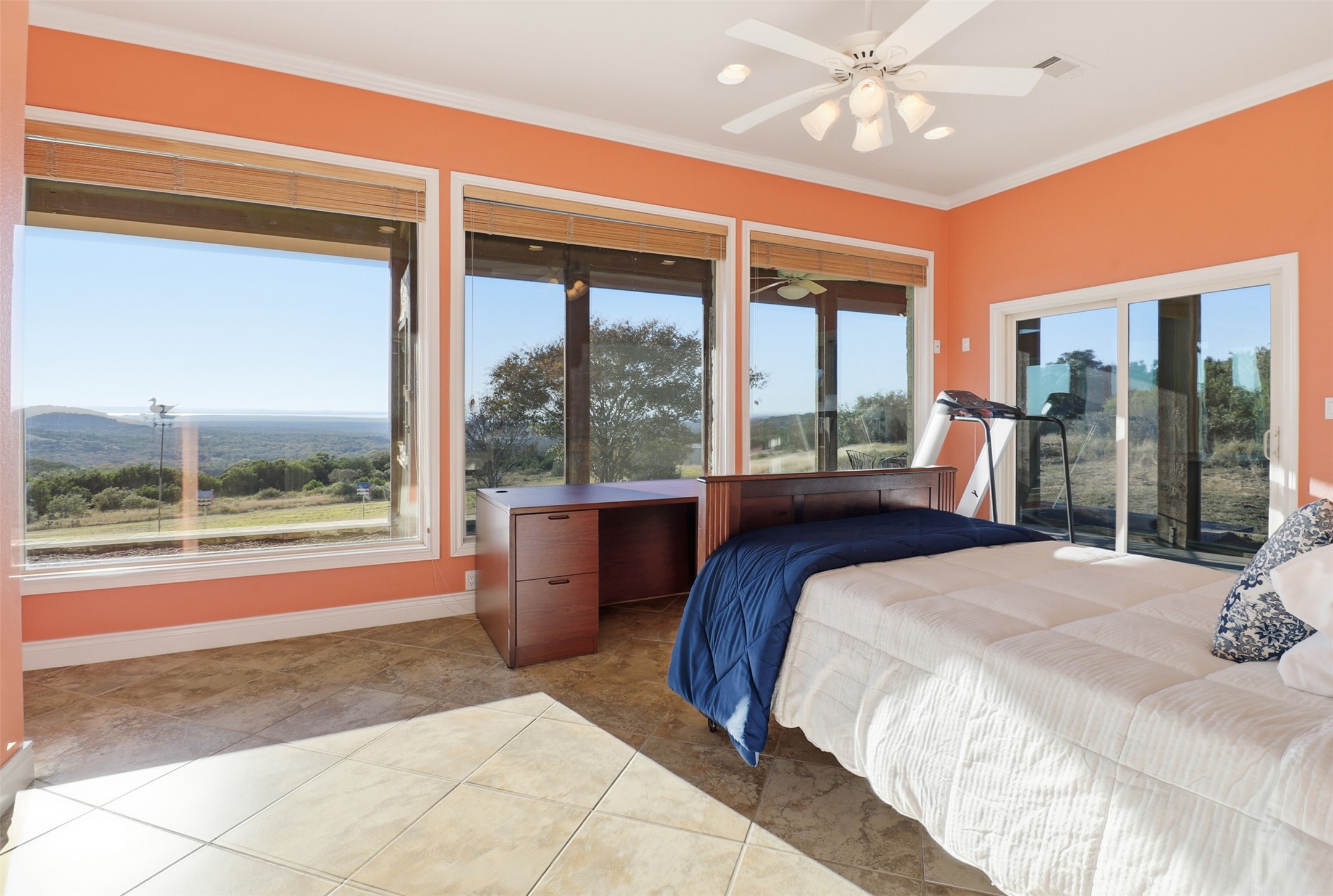 450 Threadgill Ranch Road Burnet, TX 78611 - Photo 16 of 33 a bedroom with a large bed and a large window