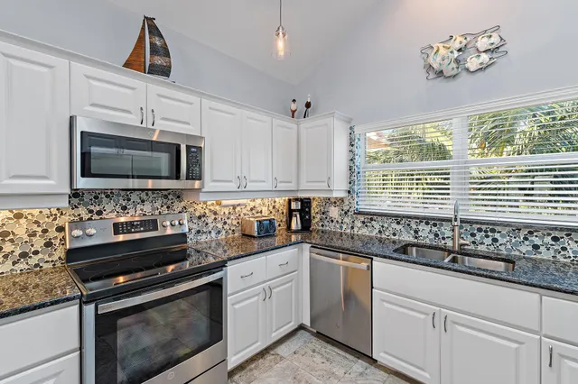 a view of a dining room with furniture and window