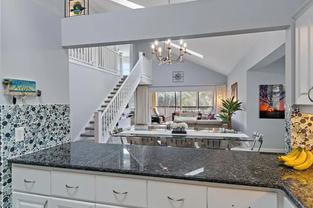 a view of a dining room with furniture and a chandelier