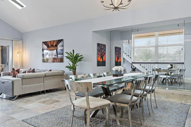 a living room with furniture and a floor to ceiling window