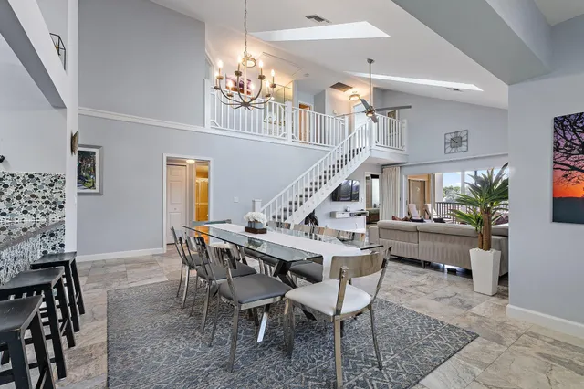 a bed sitting in a spacious bedroom next to a window